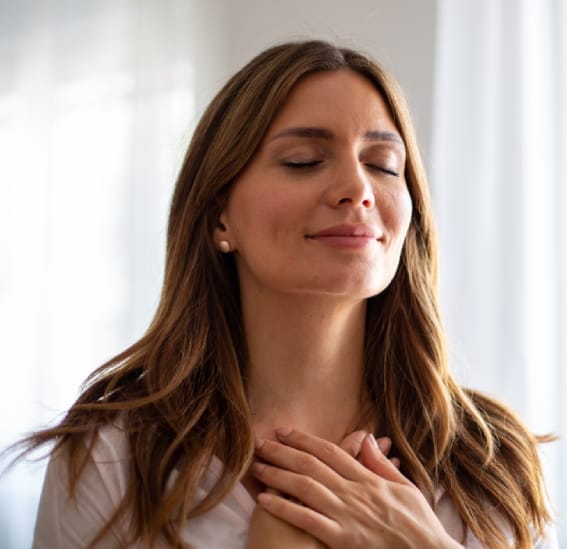 woman practicing mindfulness with gratitude and deep breathing