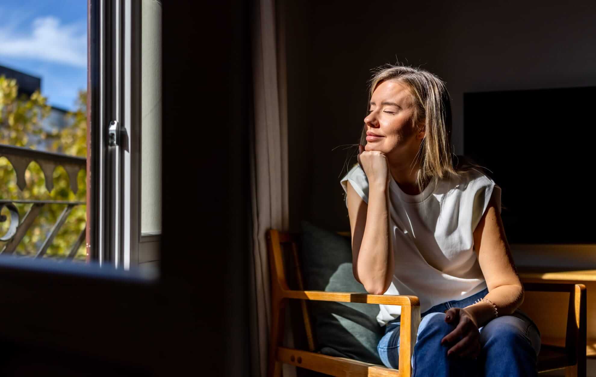 a woman relaxing in a wooden chair