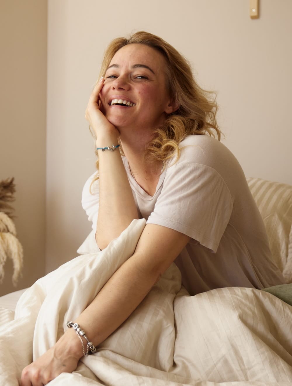 smiley woman in bed