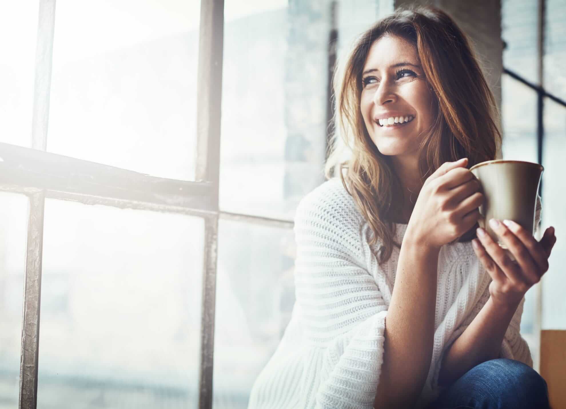 smily woman holding a mug 