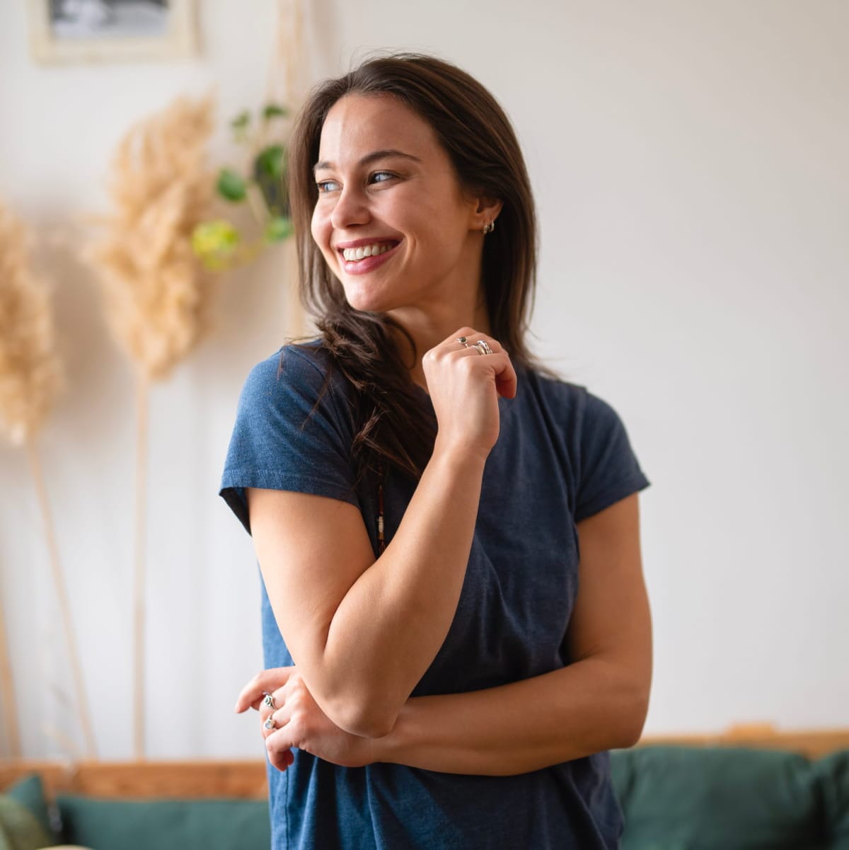 smiley young woman wearing small, simple sterling silver hoop earrings