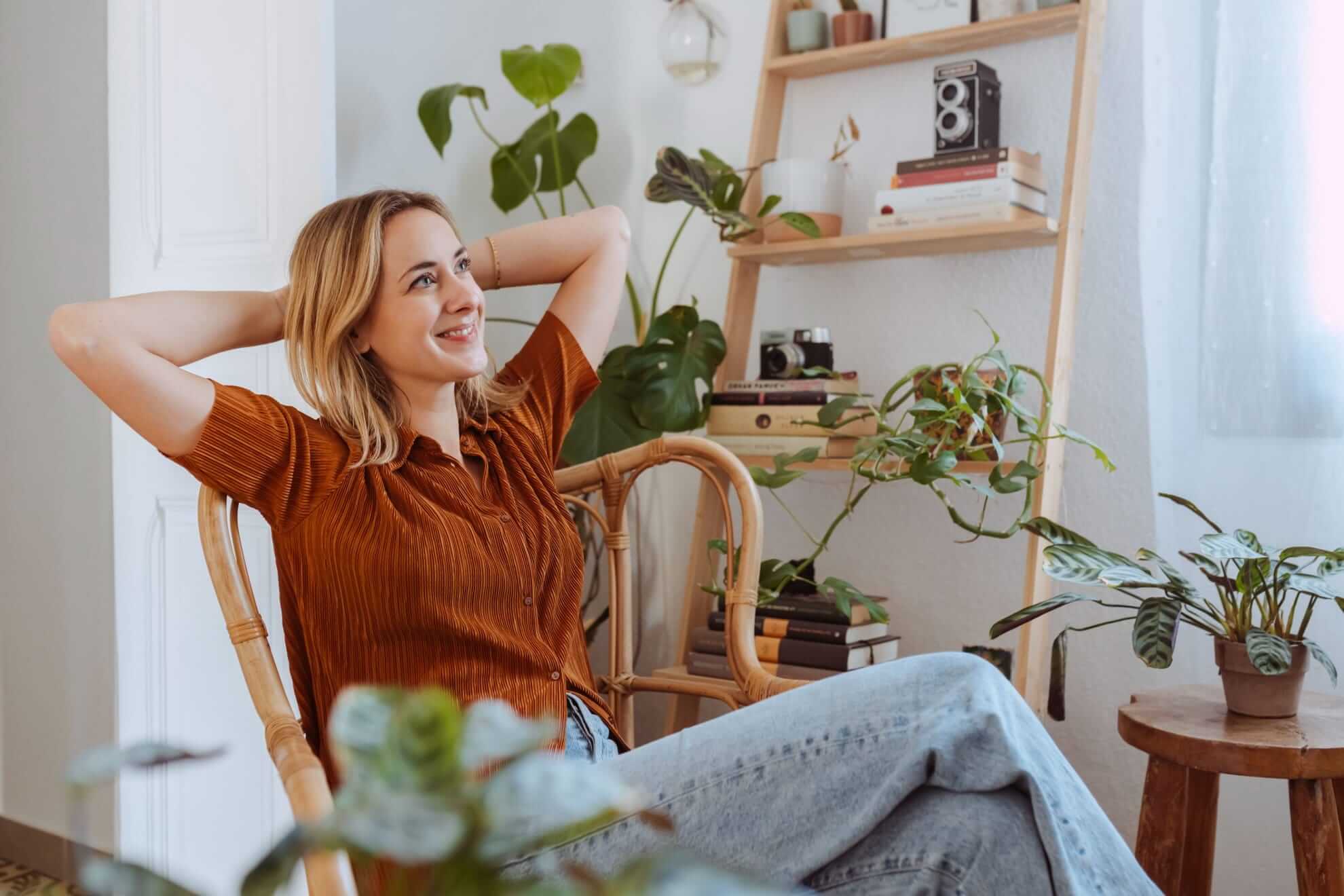 woman sitting in a cozy corner on a natural rattan armchair
