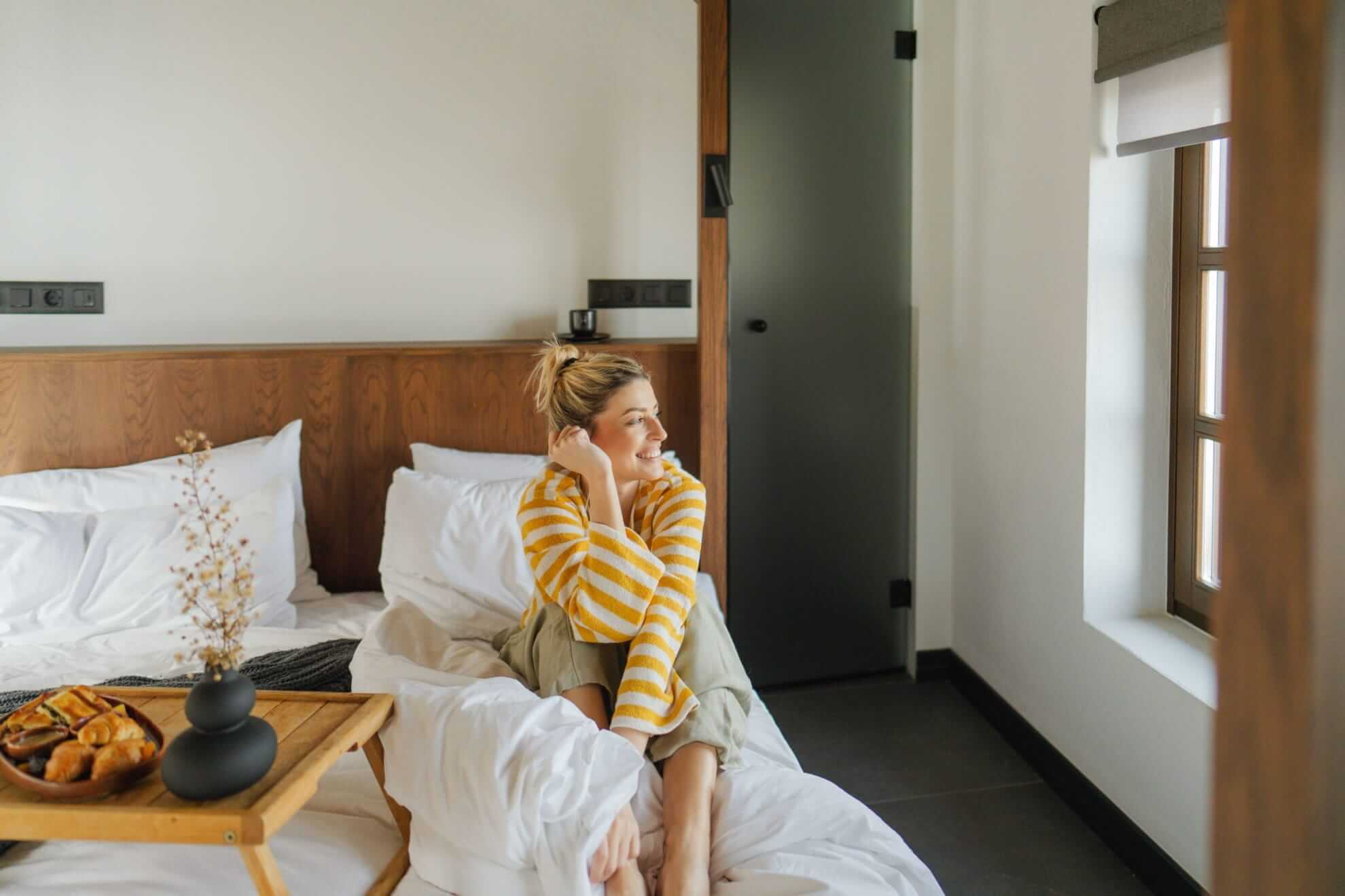 a woman sitting on a bed